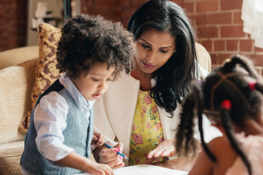 Child drawing with his mom, screen-free